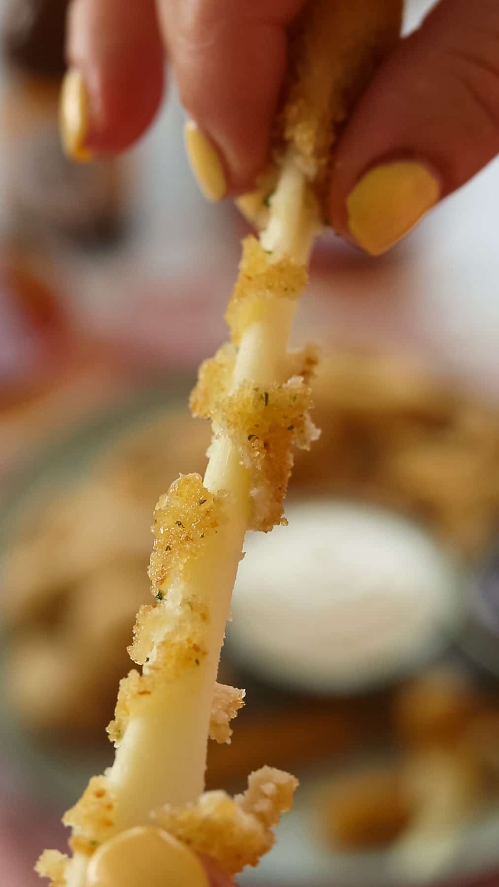 a mozzarella stick being pulled apart.