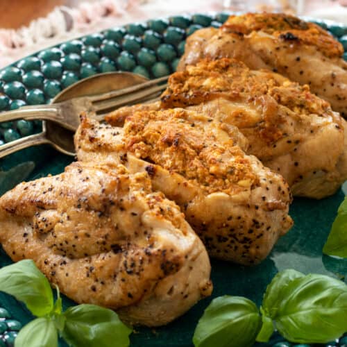 feta cheese stuffed chicken on a blue plate