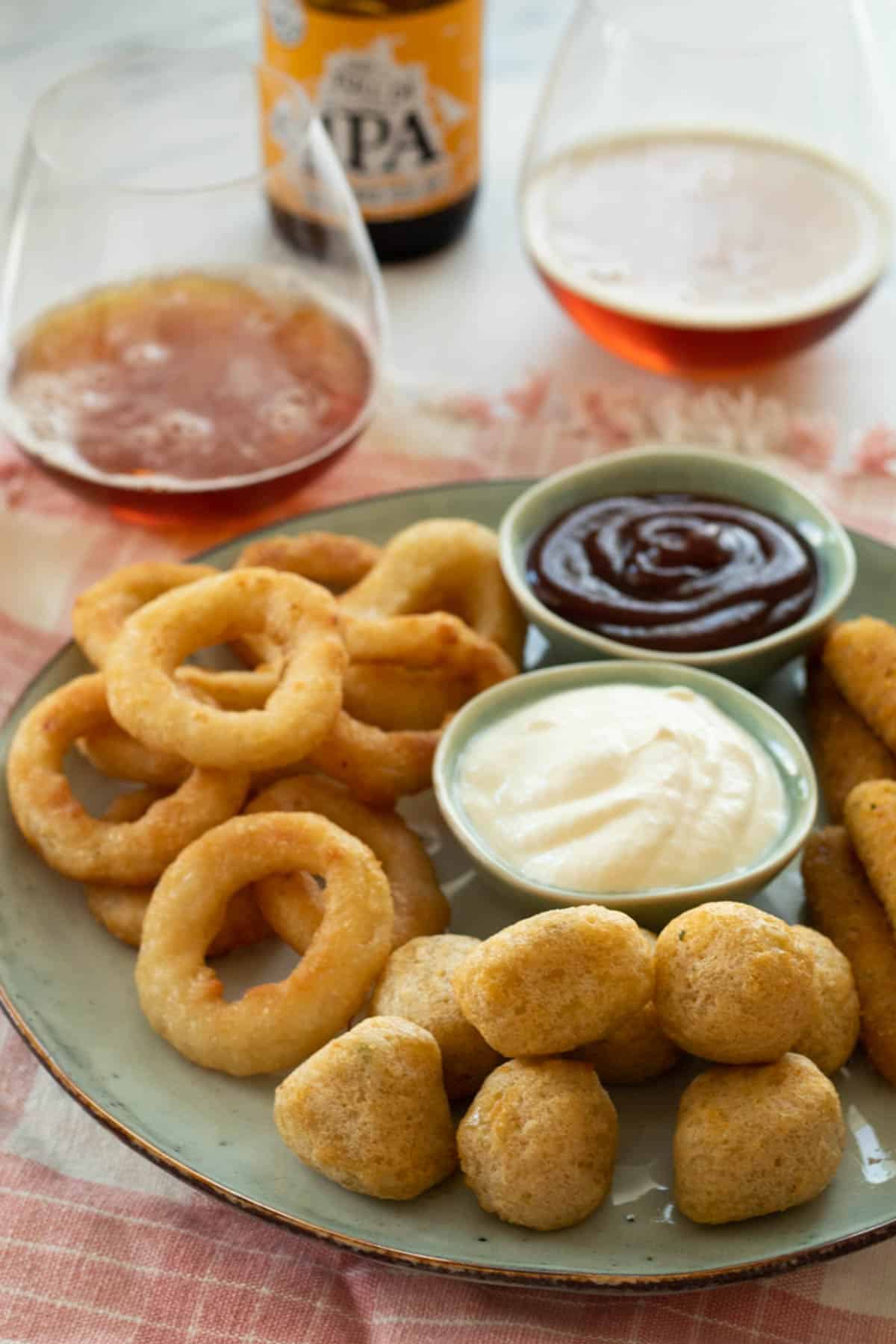 Air fried frozen food on a blue platter.