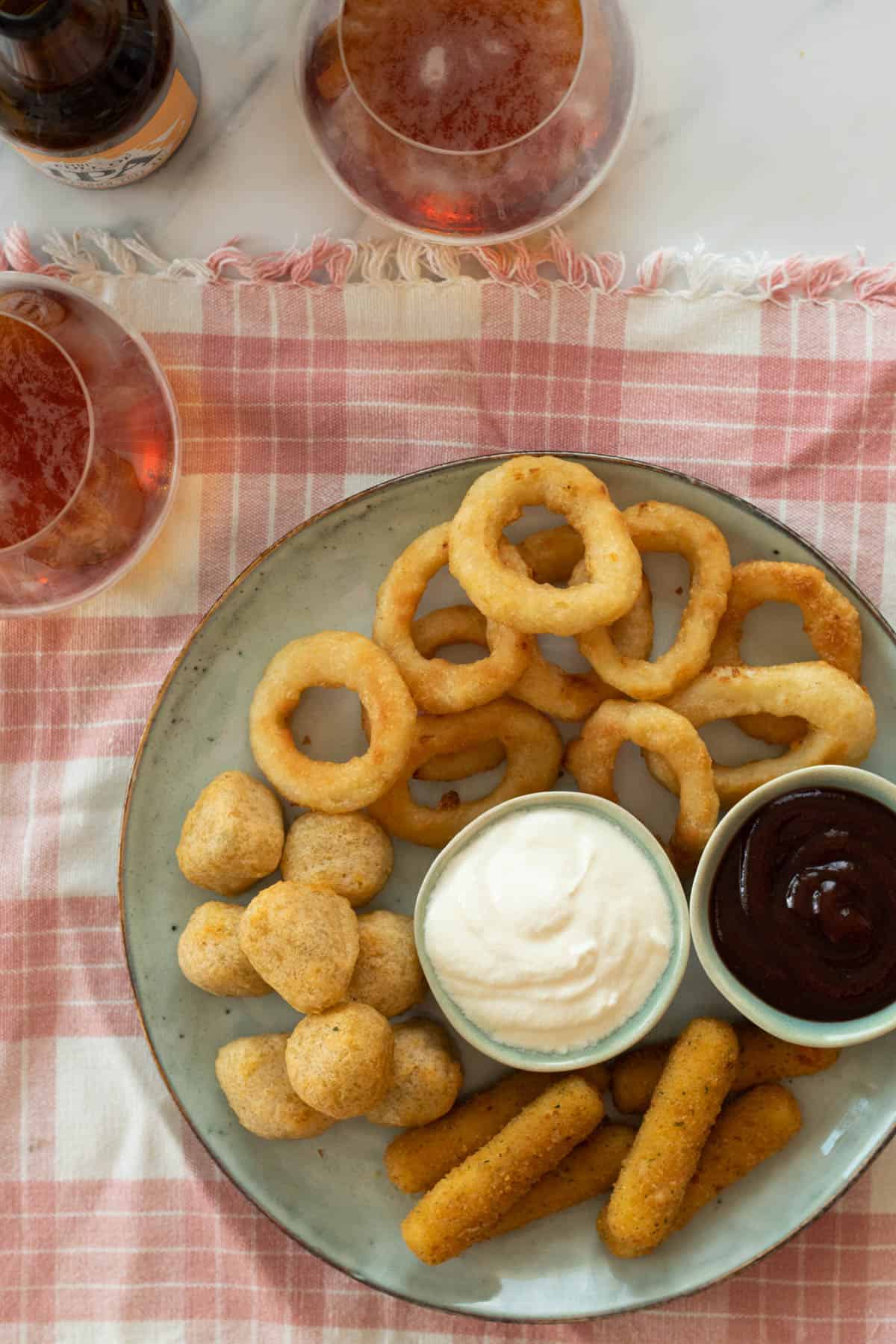 Air fried frozen food on a blue platter.