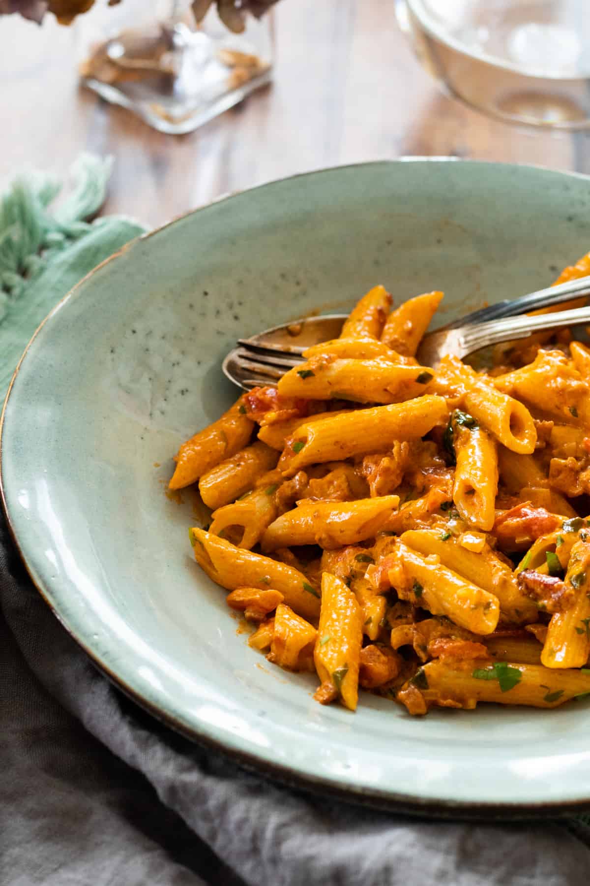 pasta with ink sauce in a blue bowl