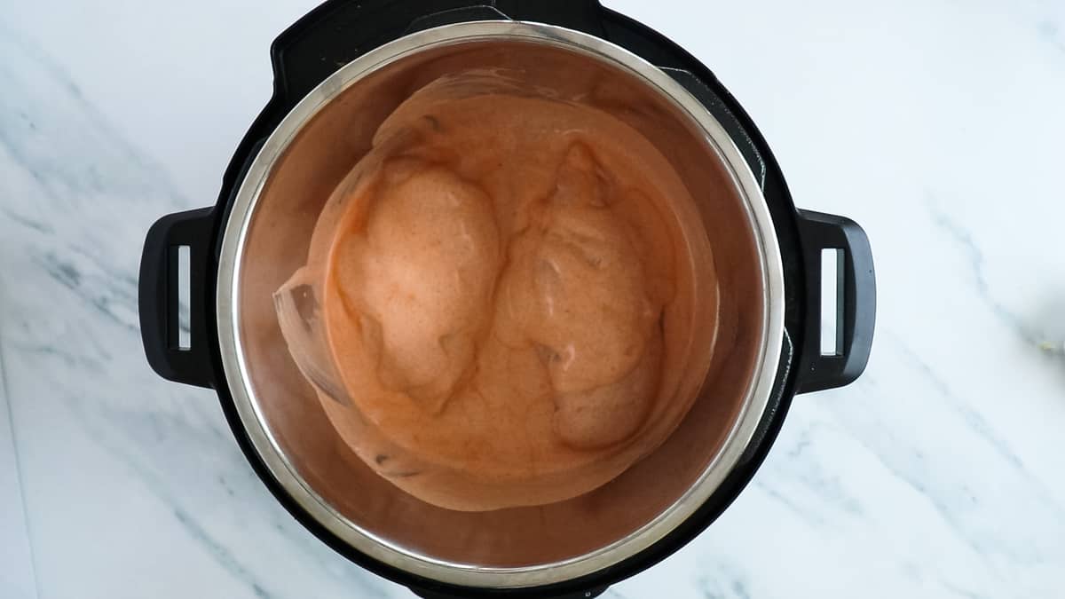 chicken breasts under sauce in instant pot