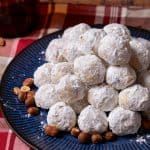 butterball cookies on a blue plate with hazelnuts