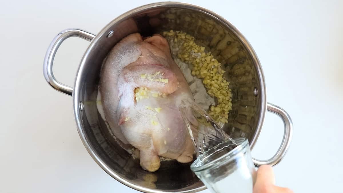 chicken in a pot with garlic and salt