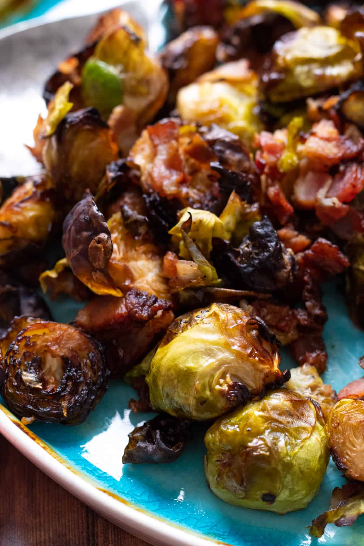 brussel sprouts with bacon on a blue plate.