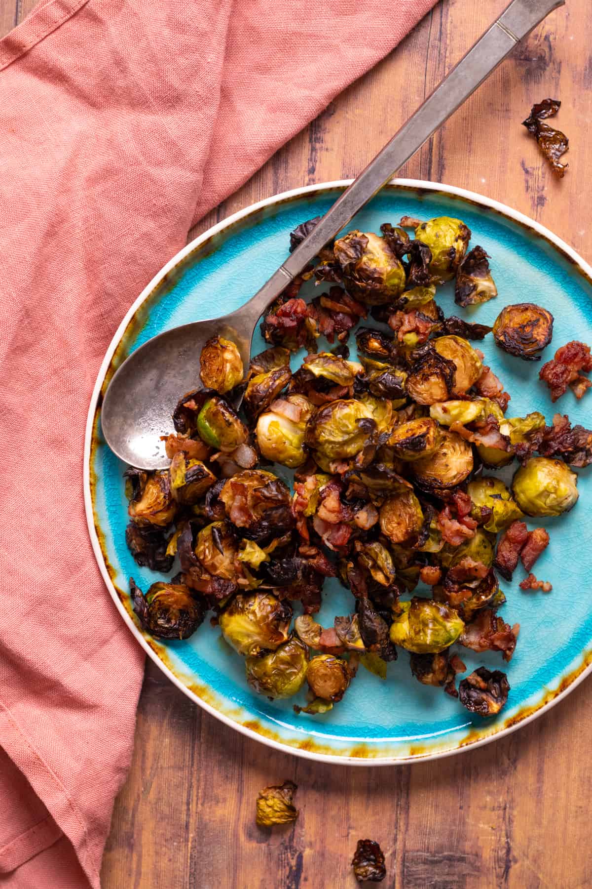 brussel sprouts with bacon on a blue plate