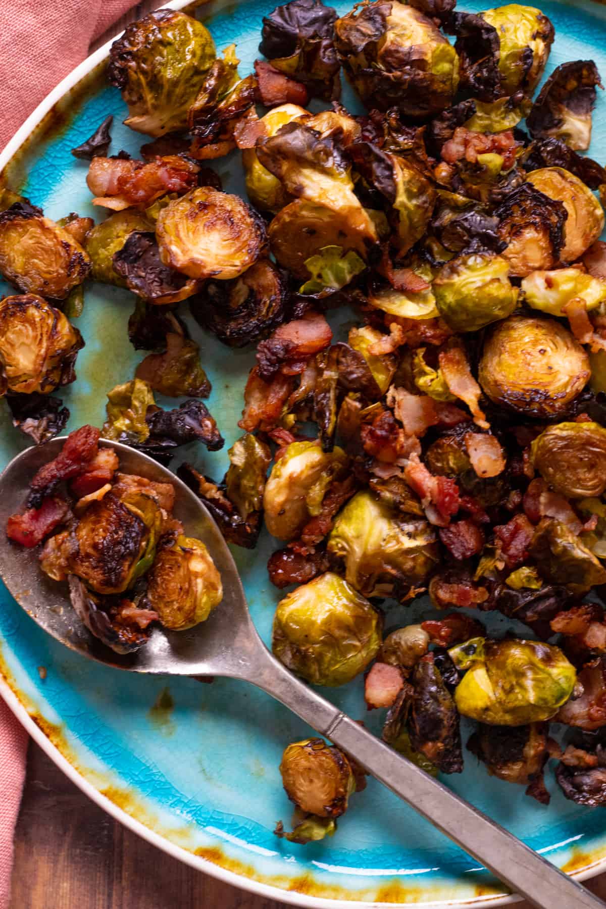 brussel sprouts with bacon on a blue plate.