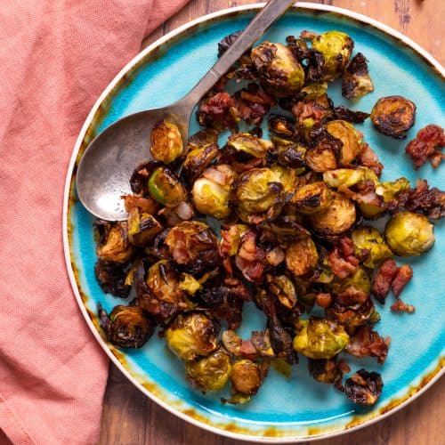 brussel sprouts with bacon on a blue plate