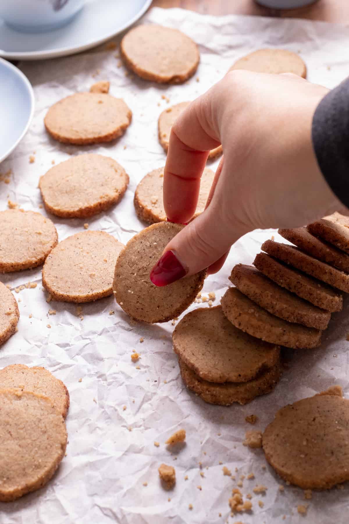 picking up a cinnamon cookie from parchment paper