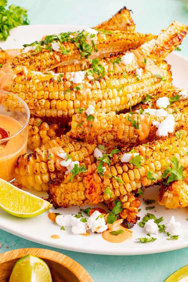 a stack of corn ribs with toppings