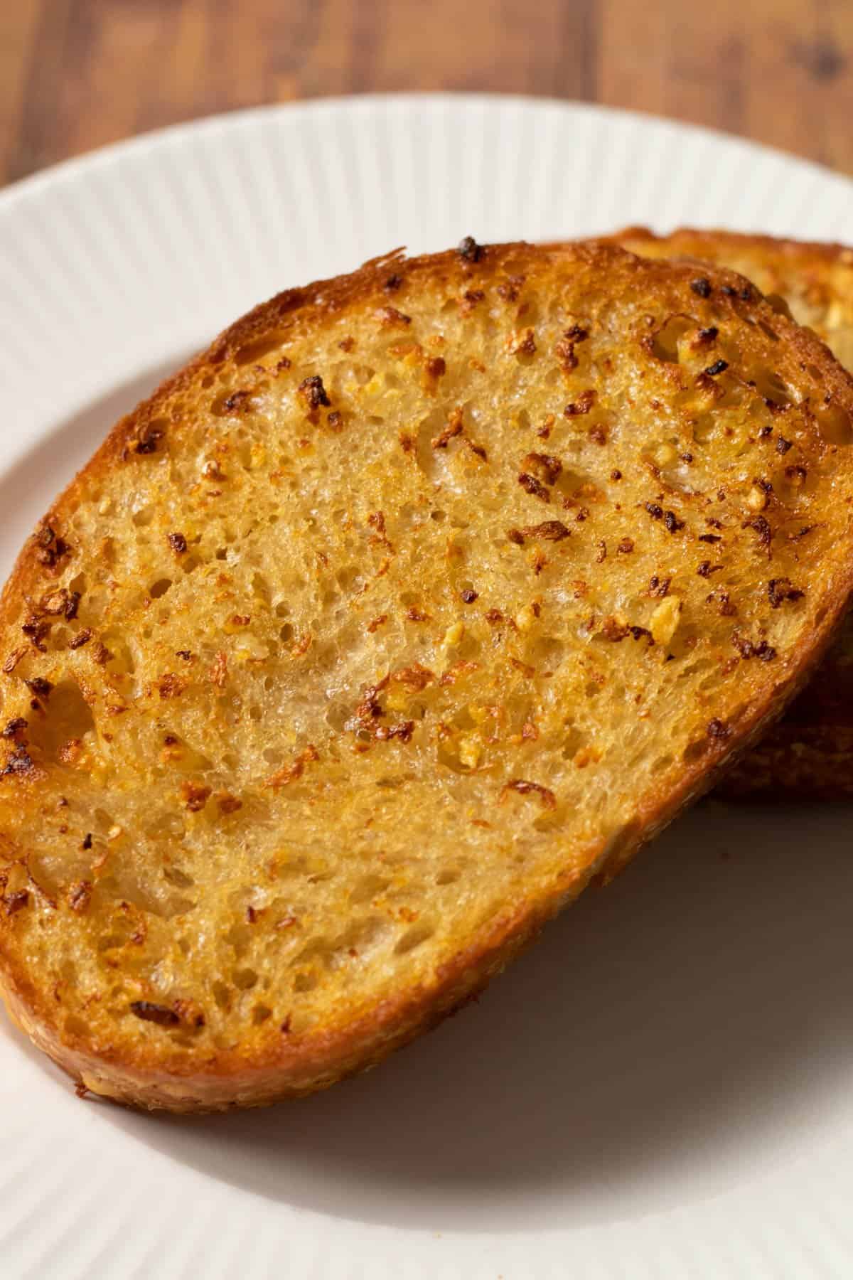 close up of air fryer texas toast on a white plate