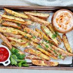 potato wedges on a baling sheet with two dip sauces