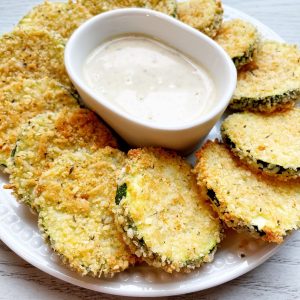 zucchini chips on a plate with dip