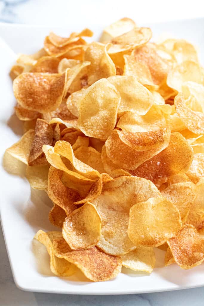 homemade potato chips on a white plate