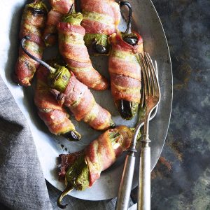 bacon wrapped jalapeño poppers on a plate