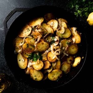 Lyonnaise potatoes in a skillet.