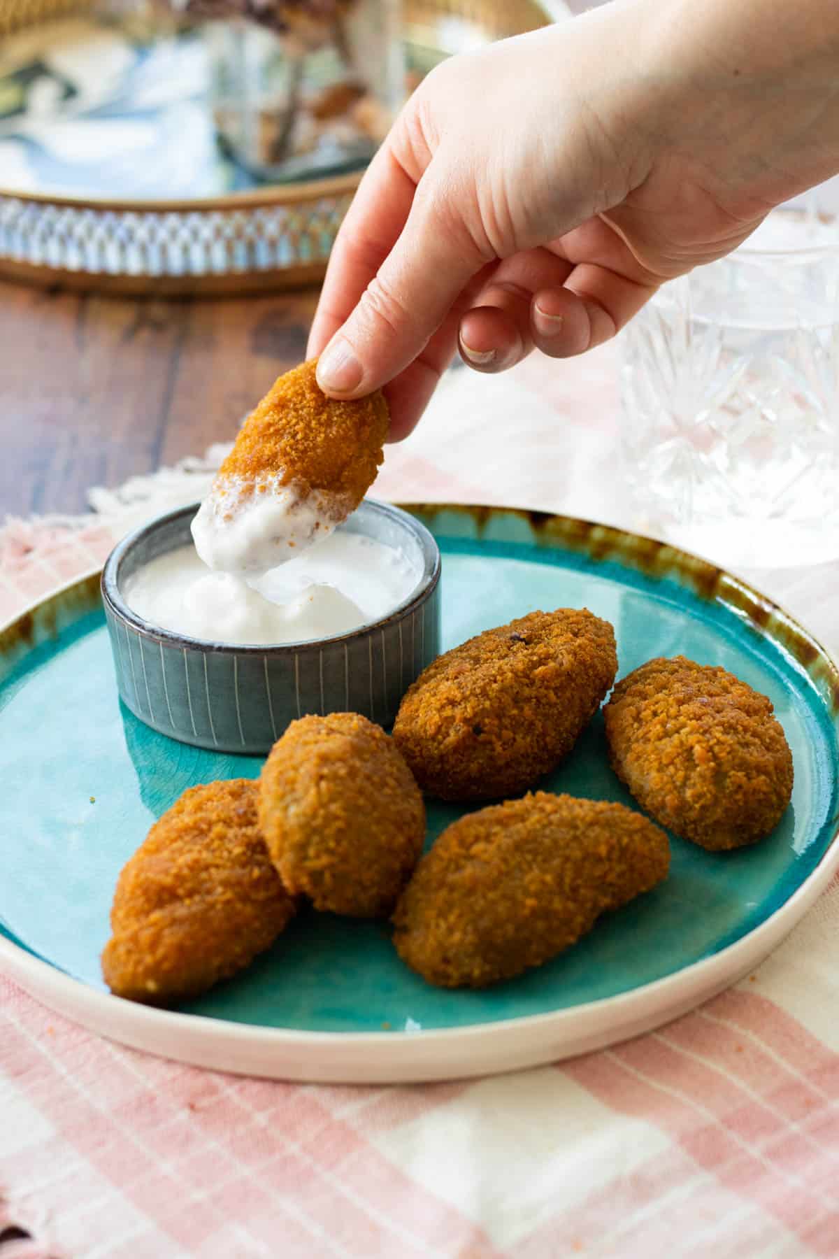 a jalapeño popper being dipped in sauce.