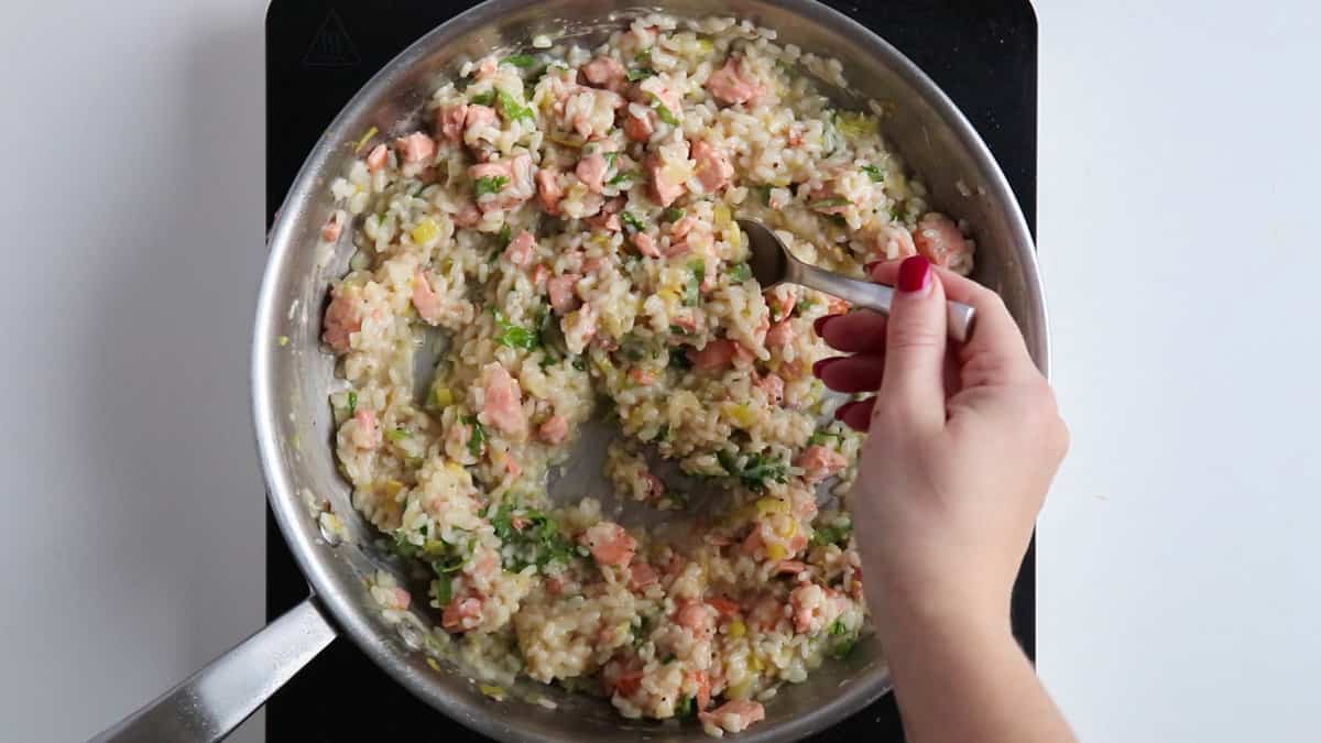 Taste testing salmon risotto.