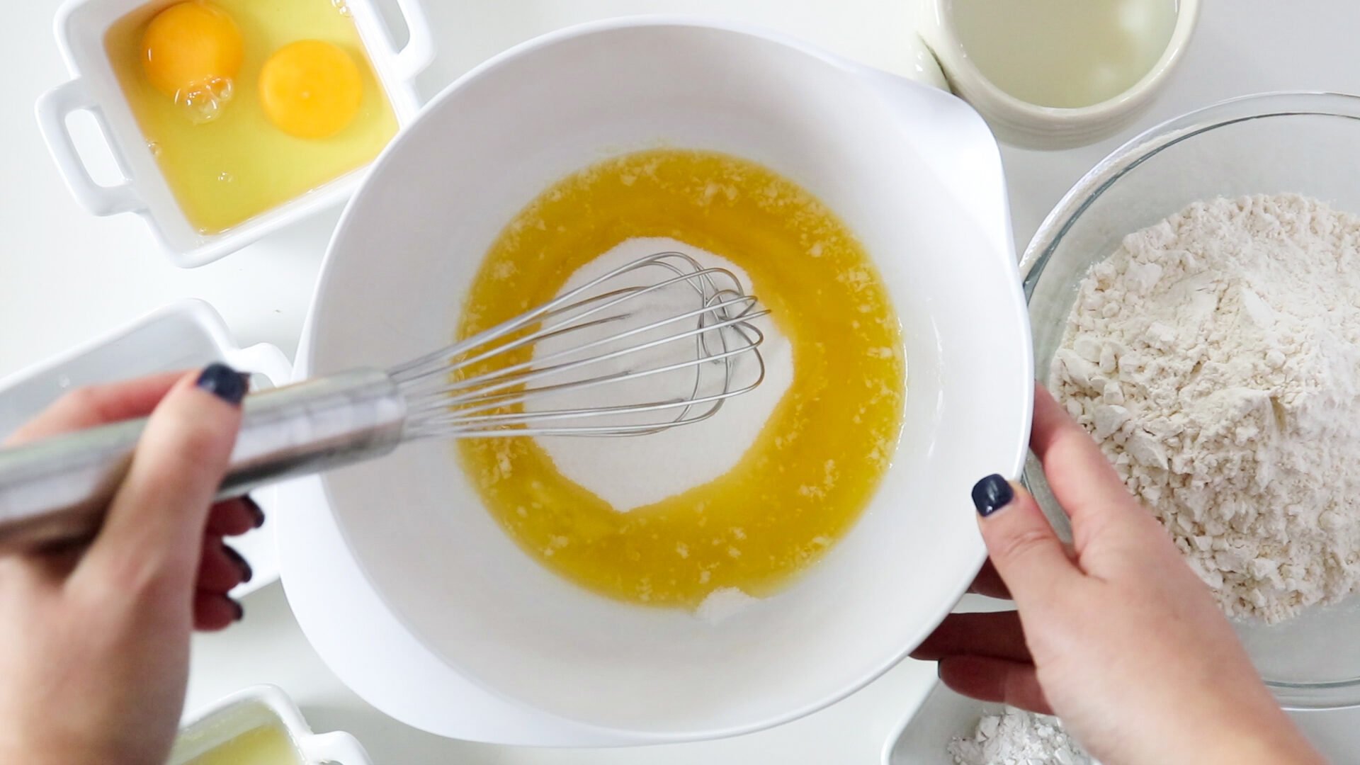 Adding sugar to melted butter.
