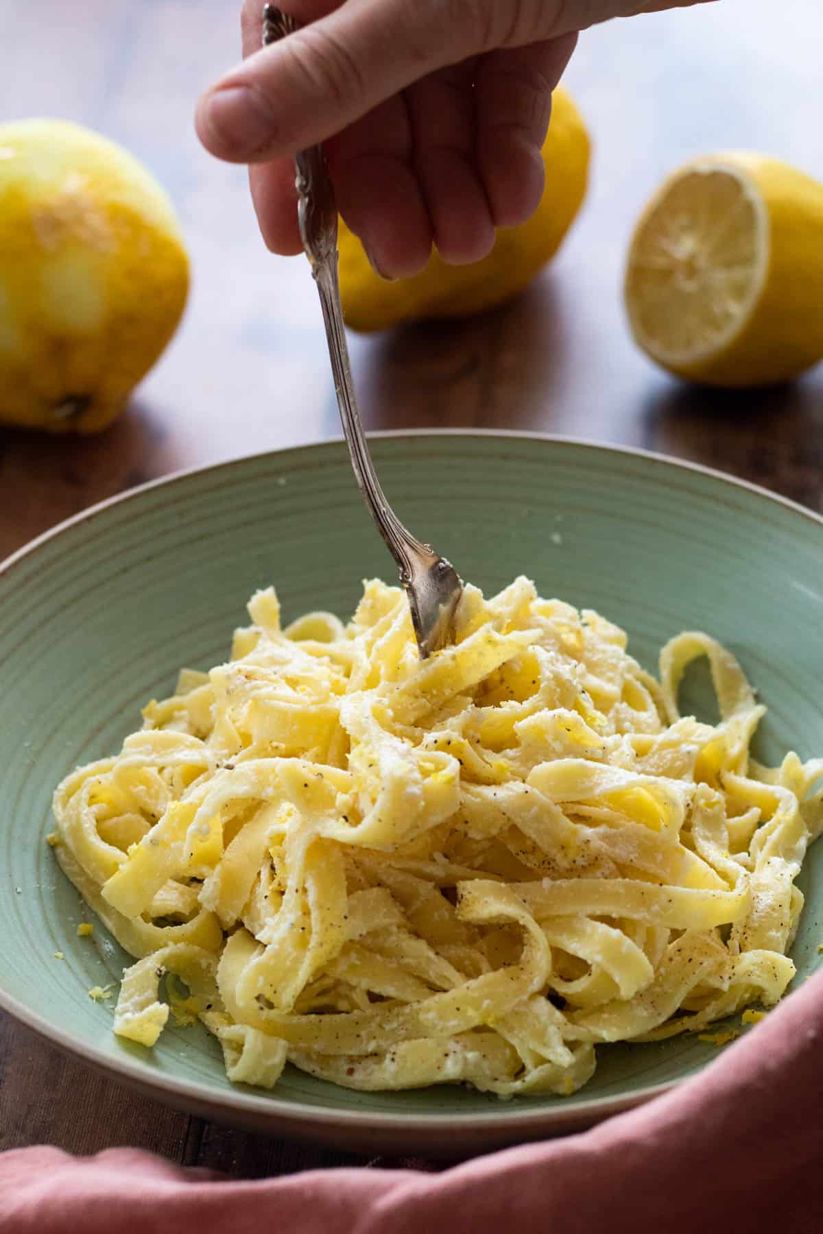 lemon ricotta pasta on a green plate.