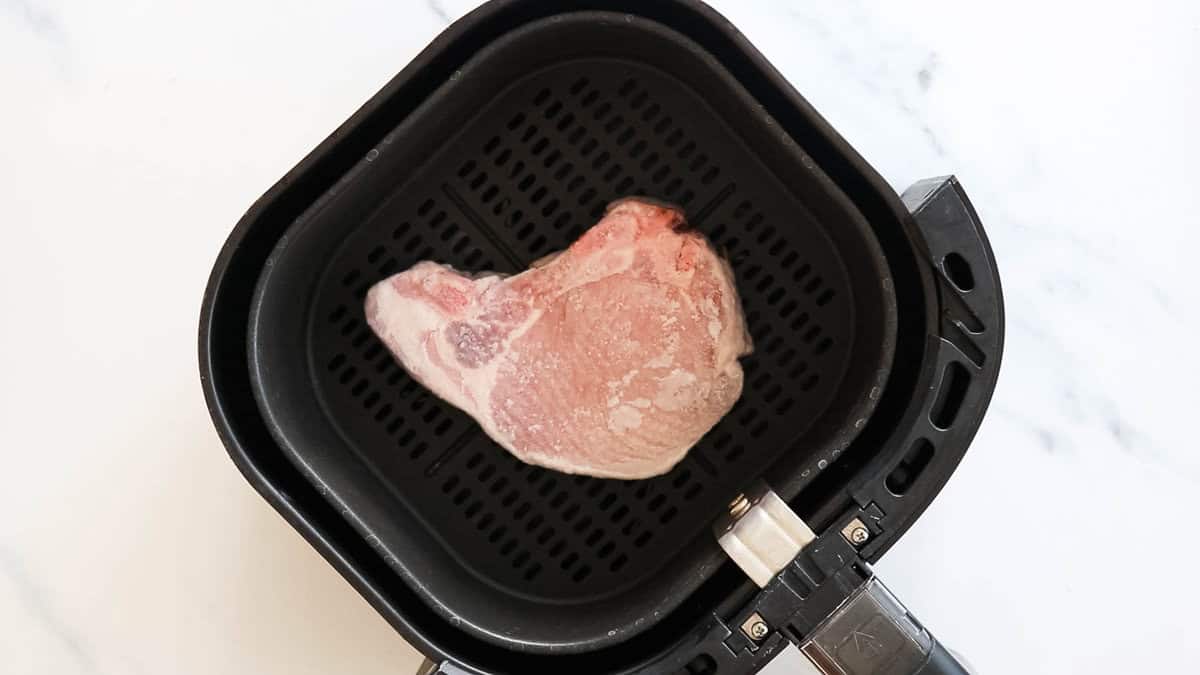 Thawing a pork chop in the air fryer.