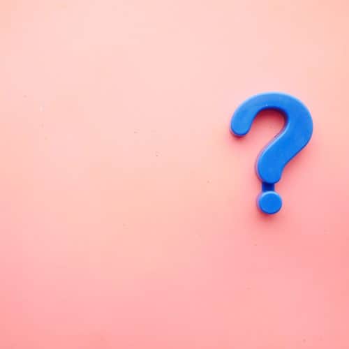 A blue question mark on a pink background.