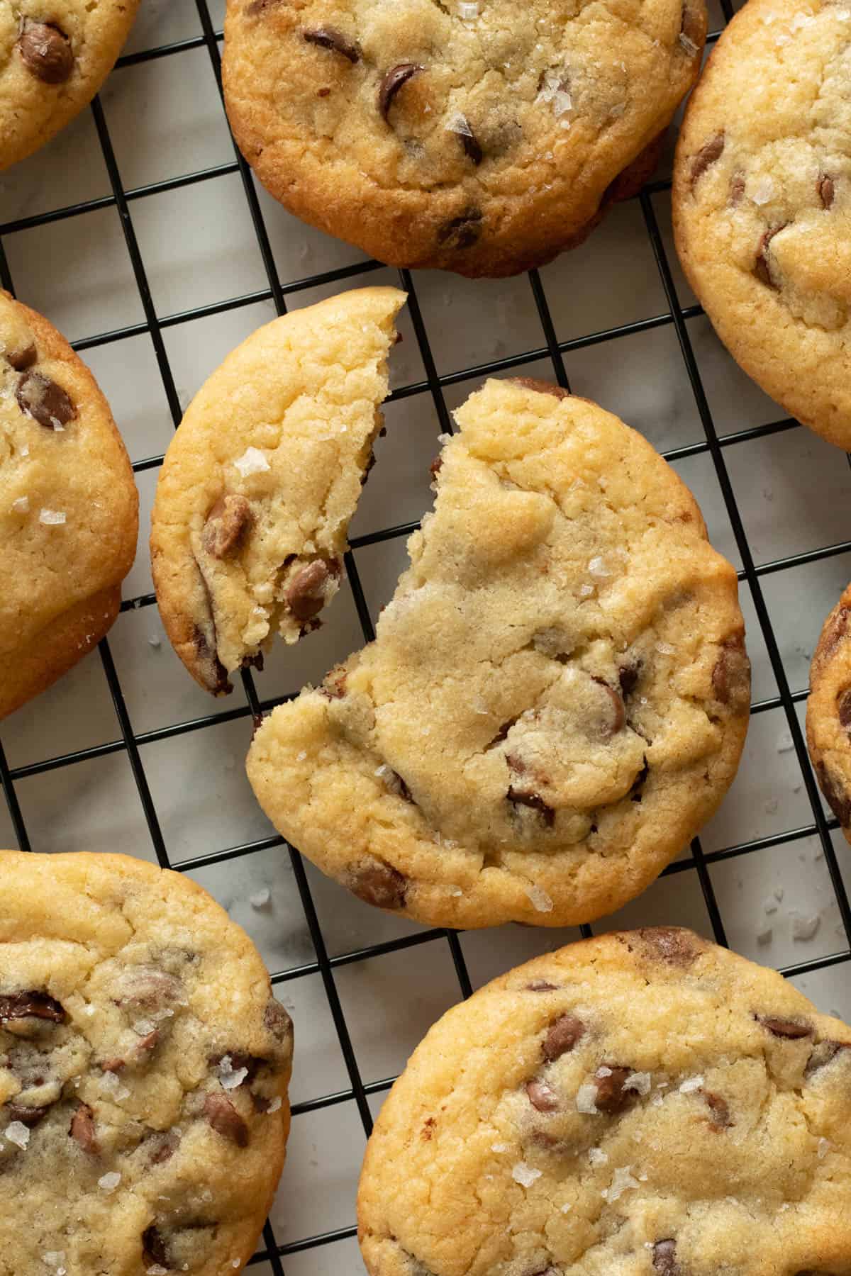 Chocolate chip cookies on a cooling rack.