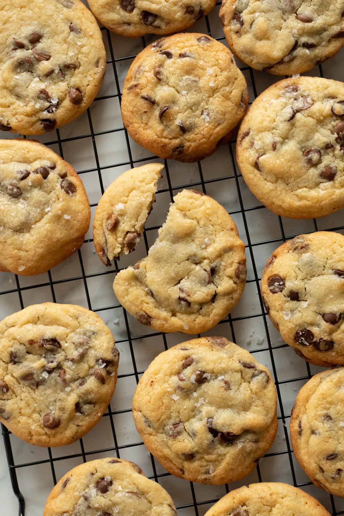 Chocolate chip cookies on a cooling rack.