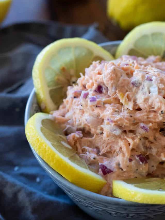 Smoked salmon pate in a bowl decorated with lemon slices.