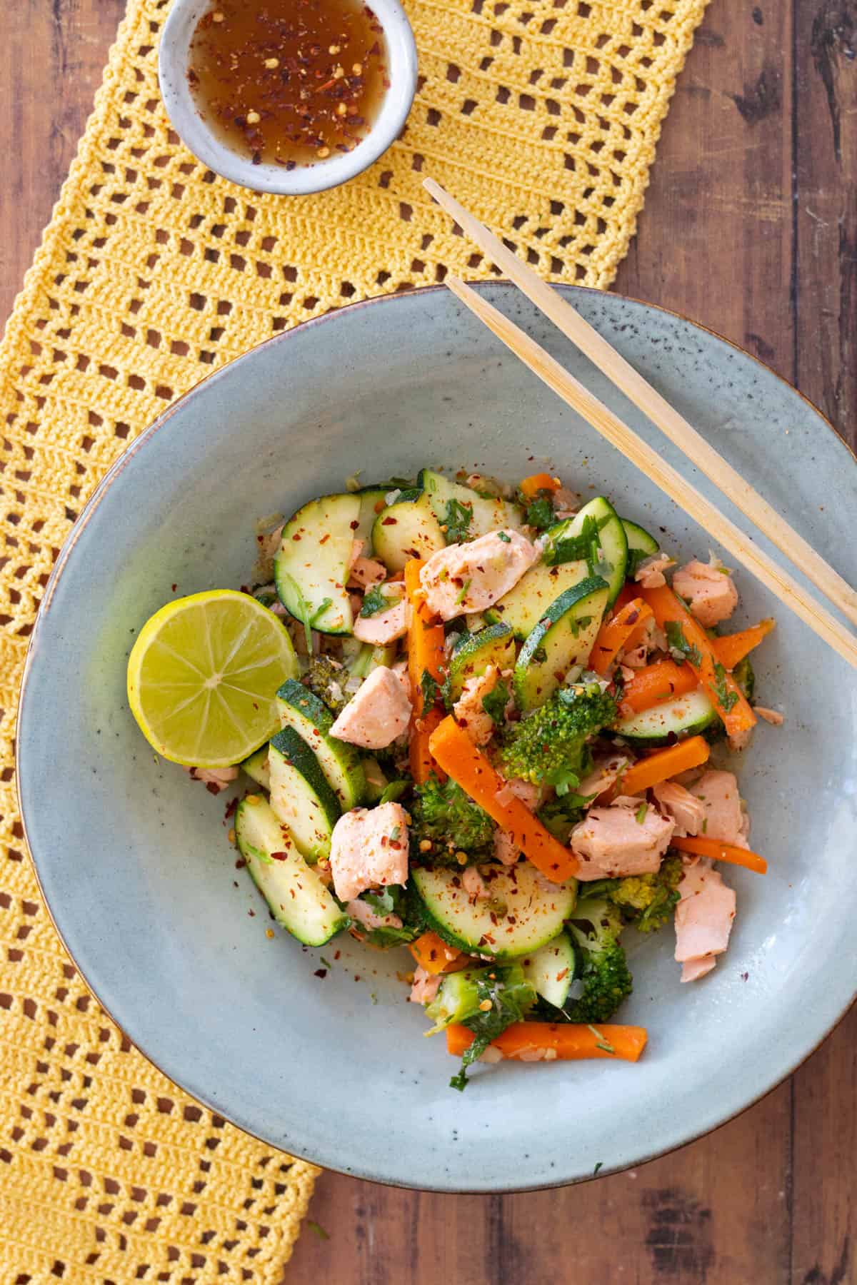 salmon stir fry in a blue bowl.