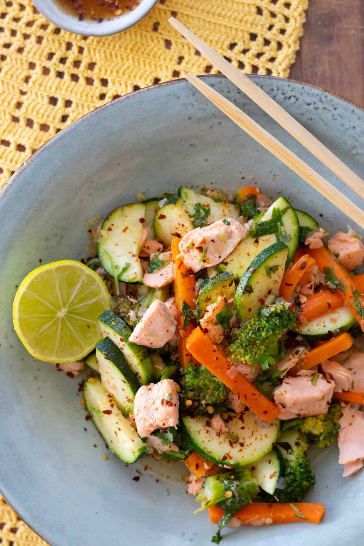 salmon stir fry in a blue bowl.