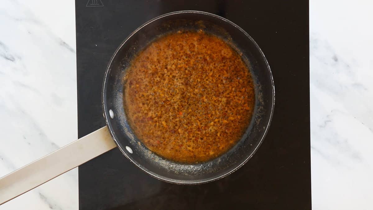 Sauce for shrimp scampi in a skillet.