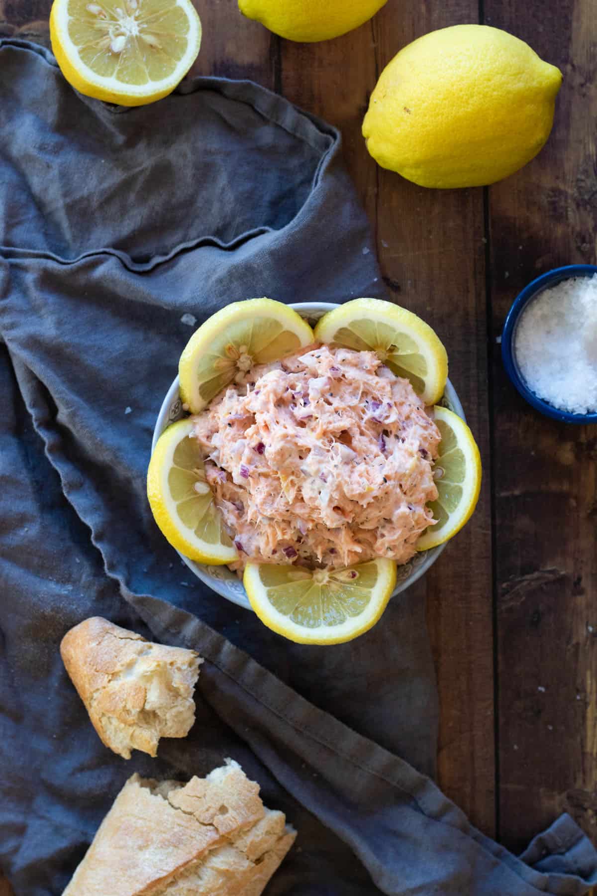 Smoked salmon pate in a bowl decorated with lemon slices.