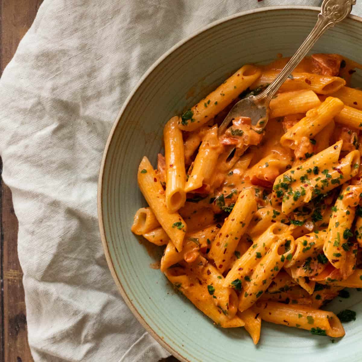 Spicy vodka pasta in a green bowl.