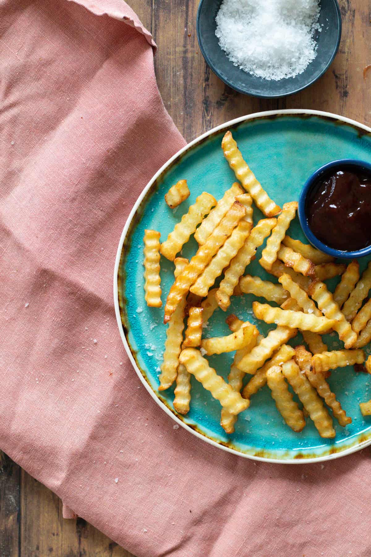 Crinkle fries on a blue plate.