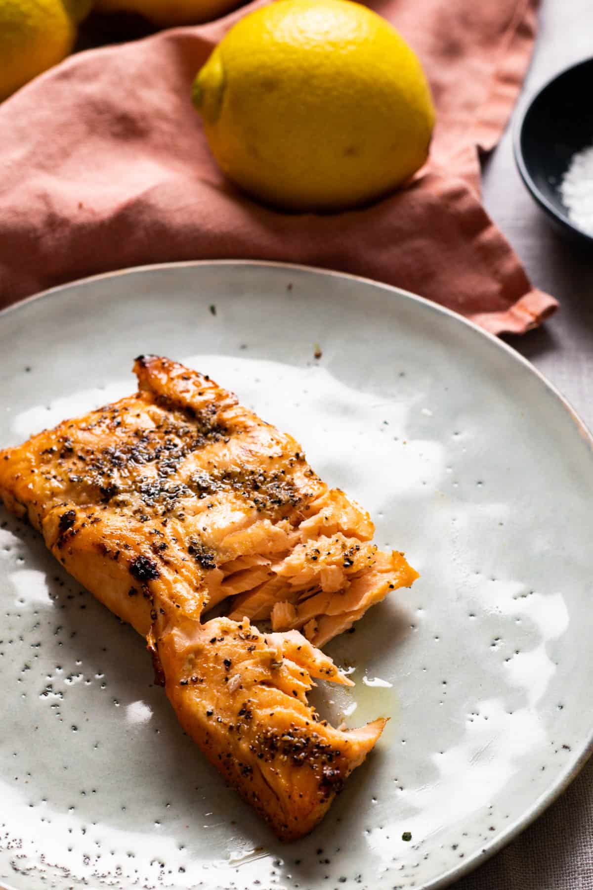 Cooked salmon on a blue plate.
