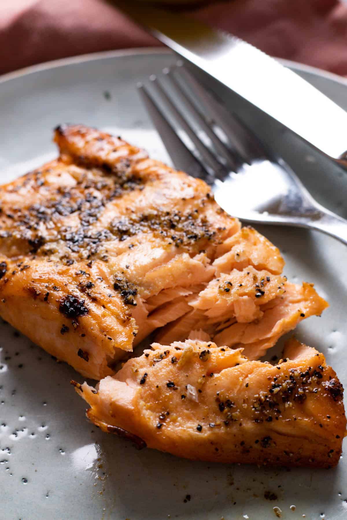 Cooked salmon on a blue plate.