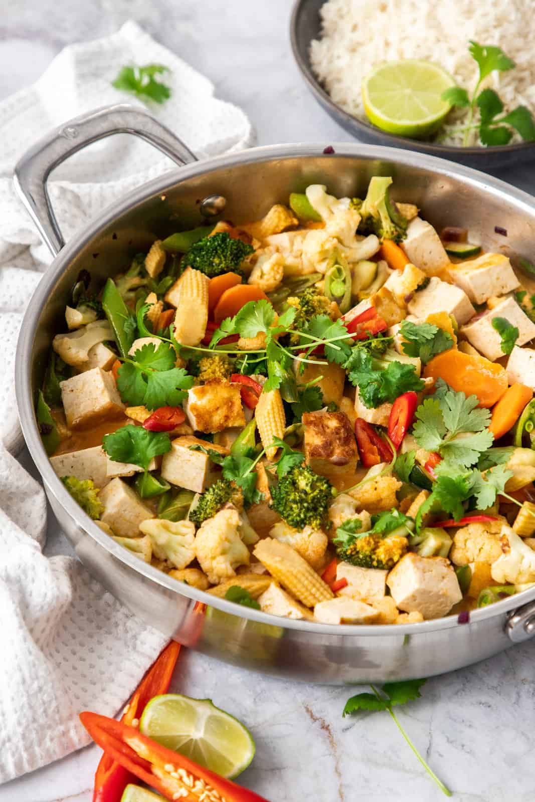 Red curry tofu stir-fry in a pan.