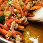 A pan with chicken teriyaki stir fry with homemade 3-ingredient sauce, carrots, bell peppers and broccoli.