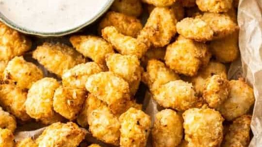 Popcorn chicken with a dipping sauce.