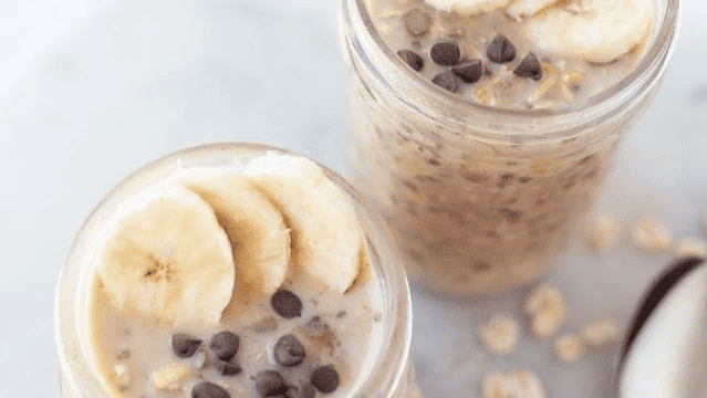 Two jars full of chocolate chip banana overnight oats.