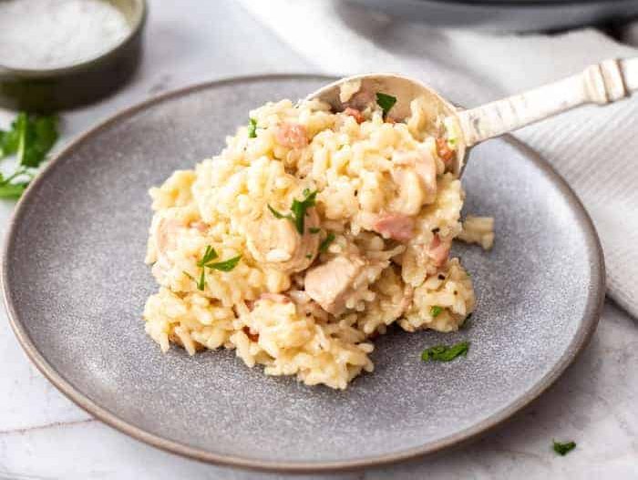 A bowl of chicken and bacon risotto.