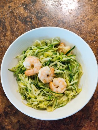 A bowl of shrimp and zucchini noodles.
