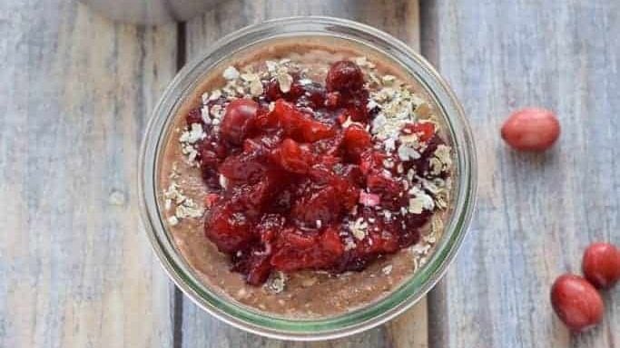 A jar with cranberry chocolate overnight oats.