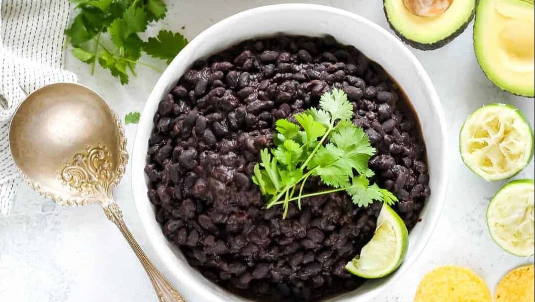 A bowl of cooked black beans.
