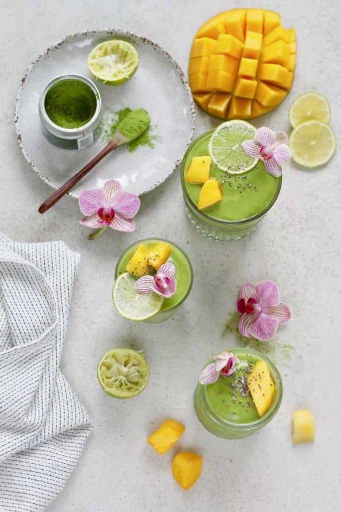 Three glasses with mango matcha green tea smoothie.