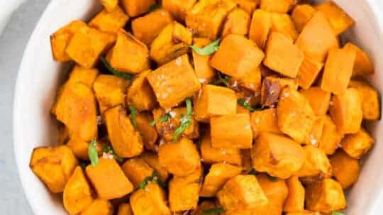 A bowl of air fryer roasted sweet potato cubes.
