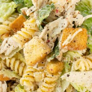 Caesar salad with chicken and pasta.
