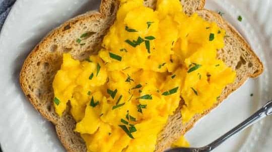 A toast topped with scrambled eggs.