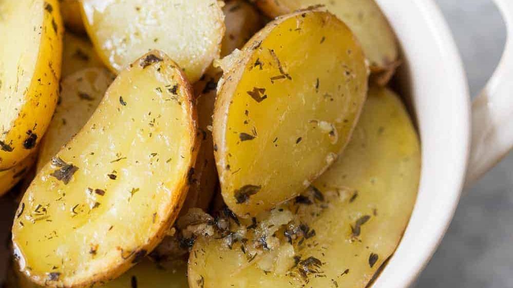A bowl of garlic herb potatoes.